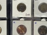 a person holding a bunch of coins in a box