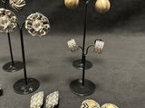 a group of silver and gold earrings and ear rings