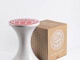a white stool with a red and white design on it