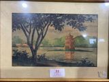 framed picture of a painting of a building on a lake