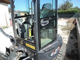 a small excavator that is parked in the dirt