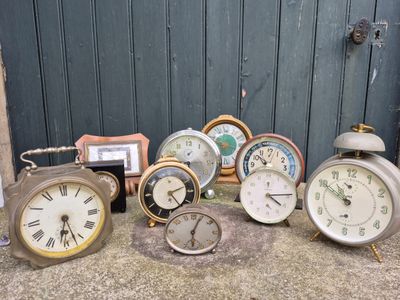 a lot of clocks that are sitting on the ground
