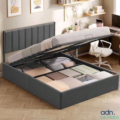 an image of a bedroom with a bed with a storage underneath it
