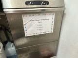 a dishwasher with a sign on it in a kitchen