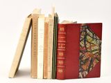 plusieurs livres sont empilés sur une surface blanche