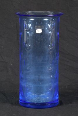 a blue glass vase that is sitting on a table