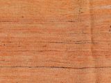 a close up of an orange rug with a black stripe on it