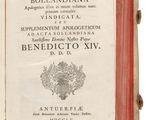 an old book is open on a white surface