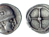 une image représentant une pièce d'argent sur laquelle figurent un visage et une croix