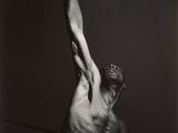 a black and white photo of a man with his arms in the air