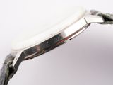 wrist shot of a watch with a white dial and black leather strap