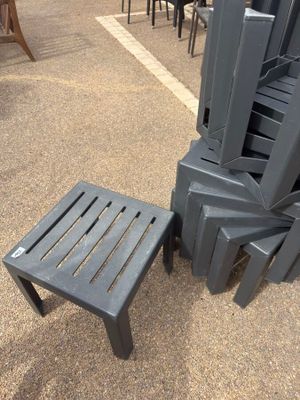 many chairs and a table in the middle of the street
