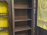 a wooden cabinet with wine bottles on top of it