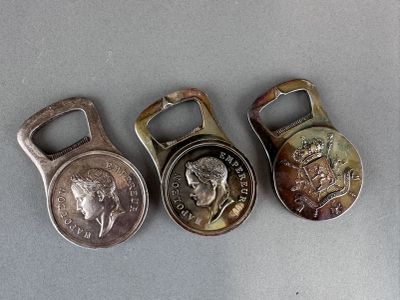three different types of bottle openers with coins on a table
