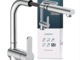 a close up of a kitchen faucet with a box in the background
