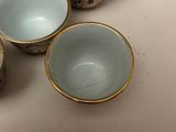 three cups are sitting on a table next to each other