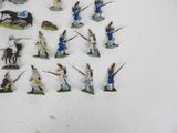 a lot of figurines of soldiers that are on a table