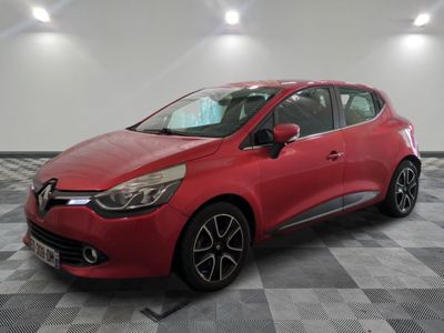 a red car is parked in a room with a checkered floor