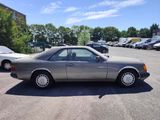 a silver car parked in a parking lot with other cars
