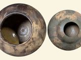 two brown vases sitting next to each other on a white surface