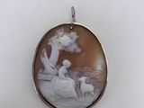 an image of a pendant with a picture of a woman and a dog