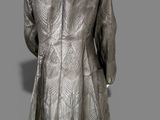 an image of a mannequin wearing a silver dress and hat
