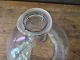 a clear glass vase sitting on a wooden table