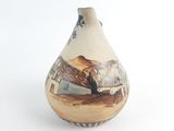 a small vase with a painting on it sitting on a table