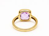 a close up of a gold ring with a purple stone