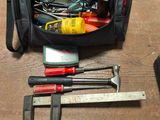 a black bag with tools in it on a table