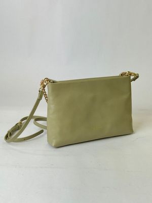 a small green purse with a gold chain strap on a white background