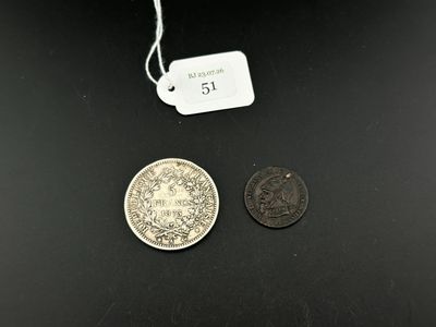 two coins that are next to each other on a table