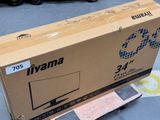 a box that is sitting on the ground next to a skateboard