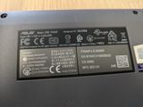 a close up of a laptop with a battery on top of it
