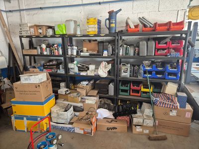 many boxes and boxes on a shelf in a garage