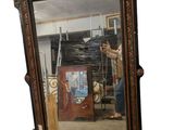 a large mirror with a man standing in front of it