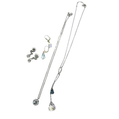 three pieces of jewelry including a necklace, earrings and a ring