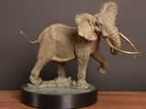 a statue of an elephant that is standing on a table
