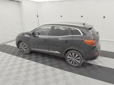the back end of a gray car parked in a garage