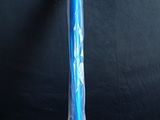 a blue toothbrush that is wrapped in plastic on a table