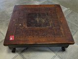 a wooden table with a decorative design on it