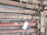 a pile of old rusted metal pipes in a warehouse