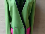 a green jacket with pink trim on a mannequin mannequin mannequin mannequin mannequin mannequin mannequin mannequin