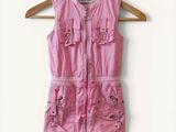an image of a pink shirt dress hanging on a hanger