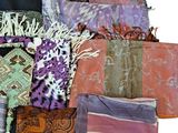 many different types of scarves and scarves laid out on top of each other