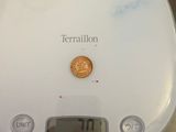 a small coin sitting on top of a digital scale