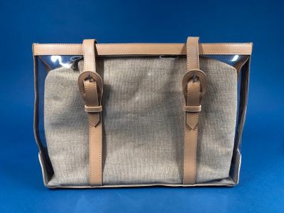 a beige and brown bag with two handles on a blue background