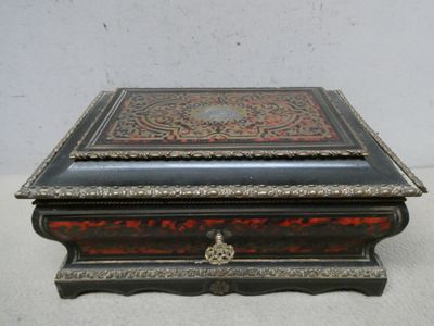 an old wooden box with a decorative design on top of it