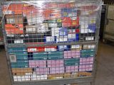a metal cart with many boxes on it in a warehouse