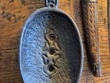 a metal spoon and a spoon rest on a wooden table